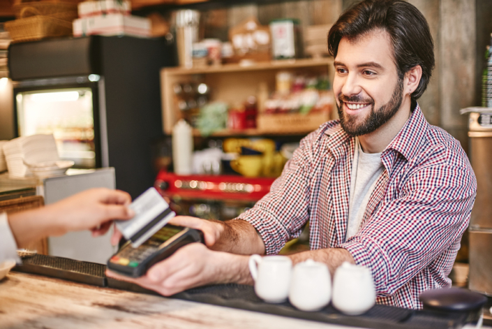You feel alive to the degree that you feel you can help others. Small business, payment, people and service concept – woman with credit card buying coffee at cafe or coffee shop lodging taxes for small business