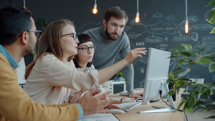 visory-c-people Team reviewing work together on a screen in a studio